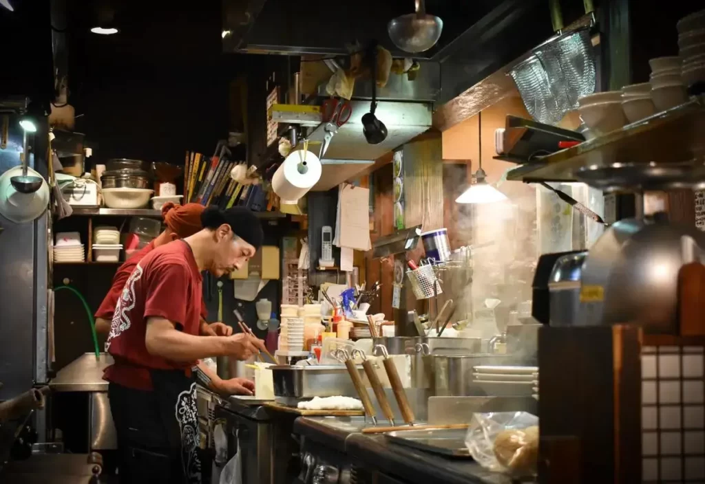 Man prepping food in a restaurant kitchen